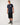 Full-length: Rip Curl Men's Sunrise Desto Tee in Dark Navy, full-length model view styled with black denim shorts