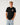 Front: Rip Curl Men's Wettie Passage Icon Tee in Black, front view showing small circular chest print